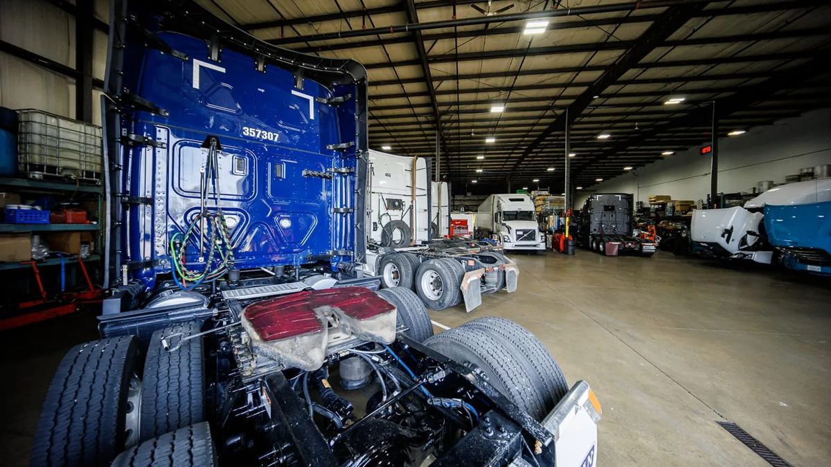 Semi-truck tractors inside the Truck Clinic repair workshop in Romeoville, Illinois